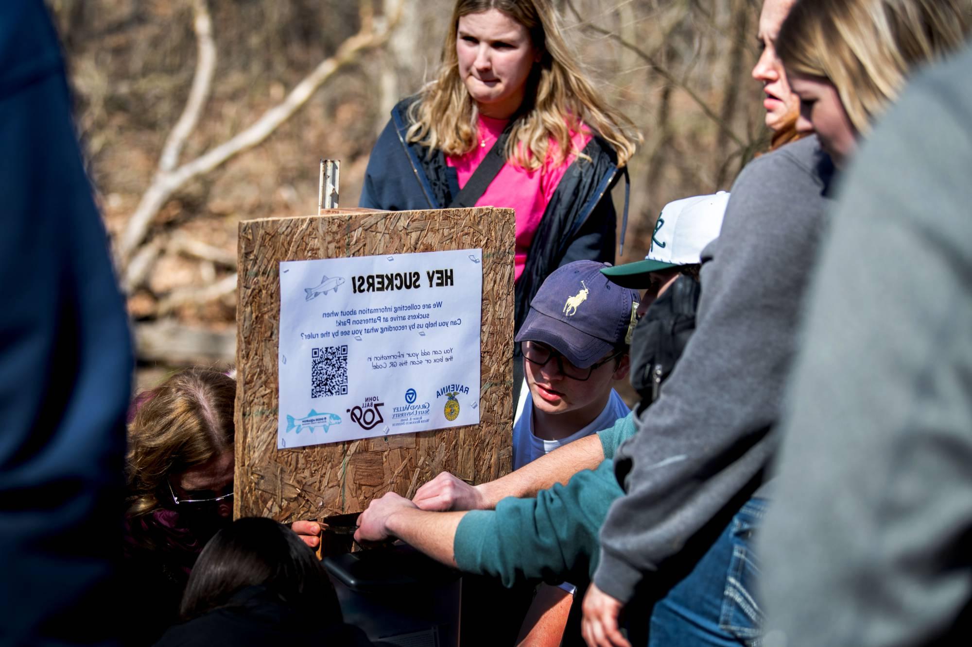 Ravenna High School students set up a sucker migration monitoring site